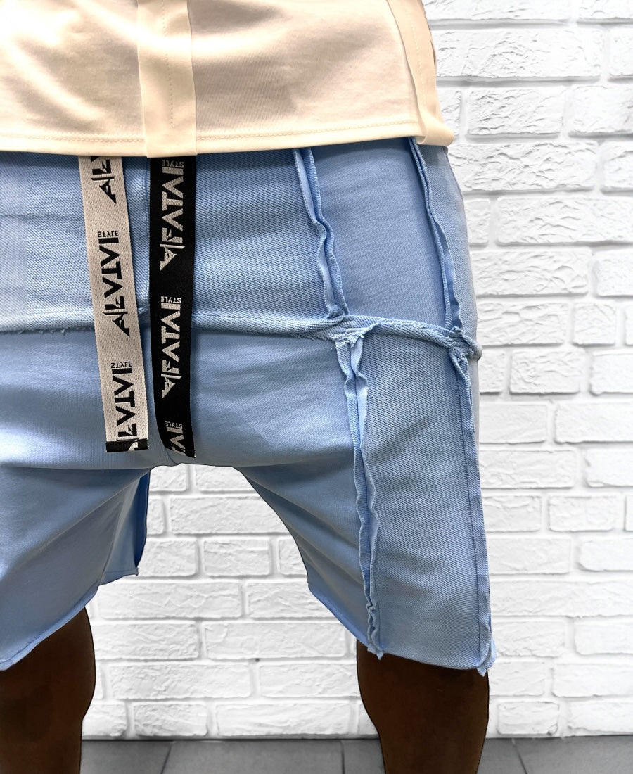 Pantaloni bleu cu multiple taieturi
