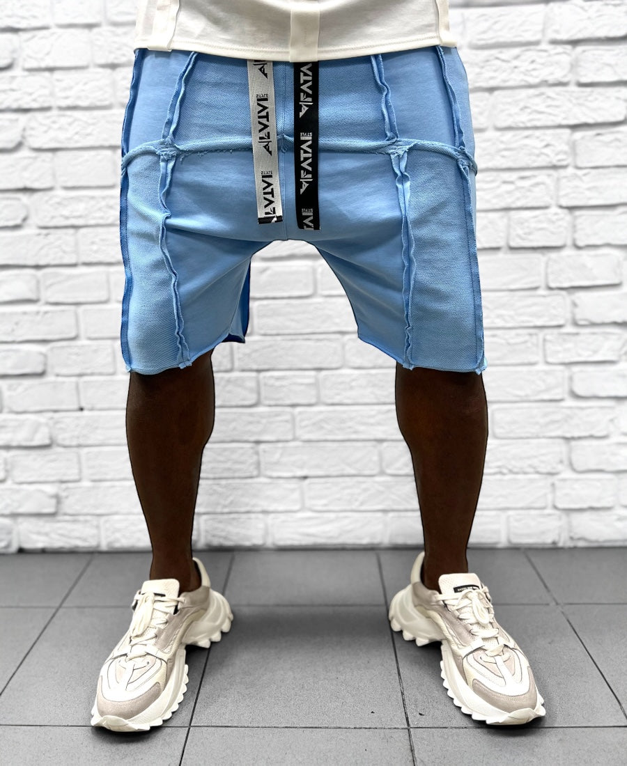 Pantaloni bleu cu multiple taieturi