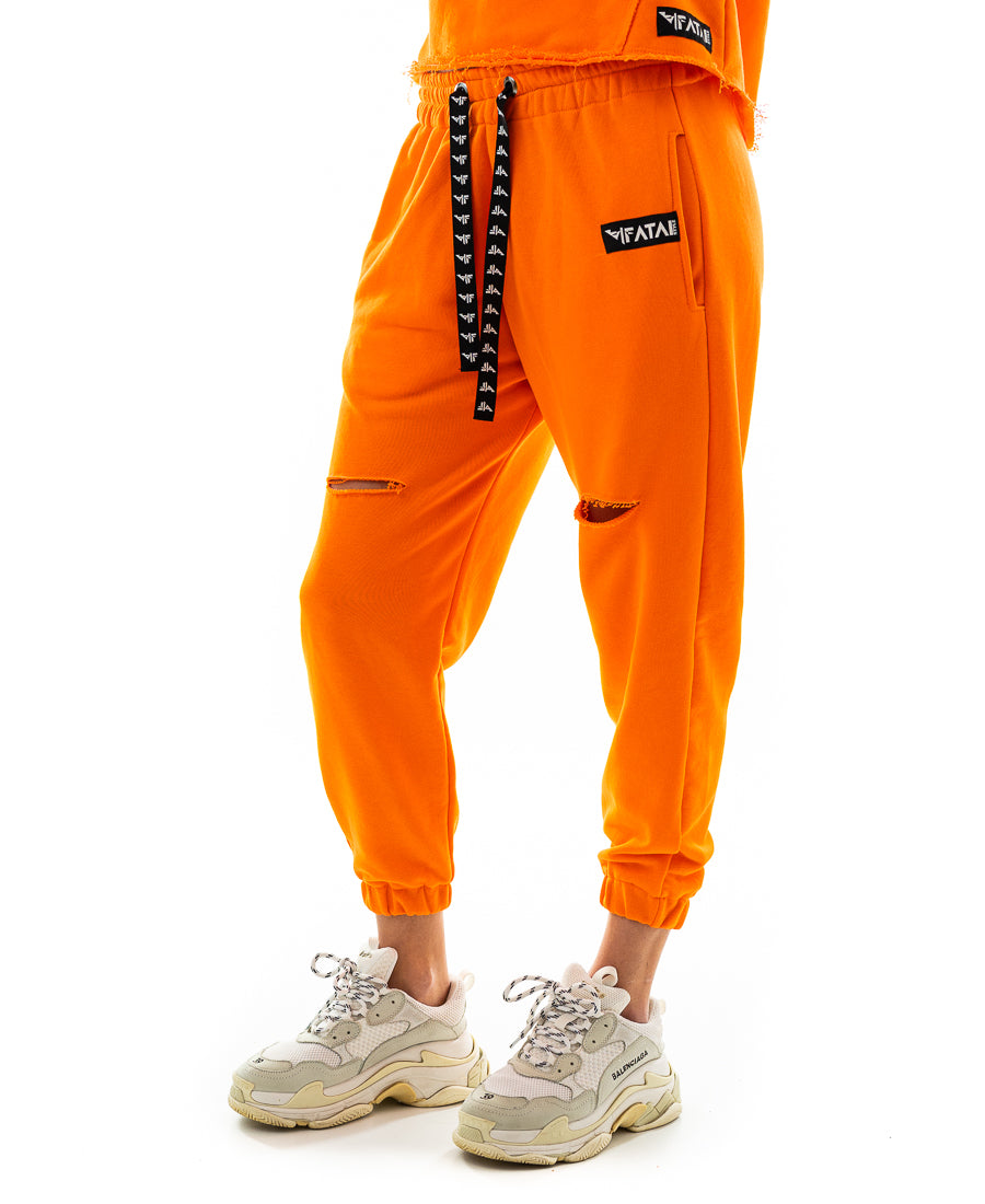 Pantaloni portocalii cu o taietura pe picior si elastec la glezna